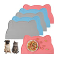 Cat-shaped pet food mats in pink, blue, gray for dogs and cats with bowl of kibble