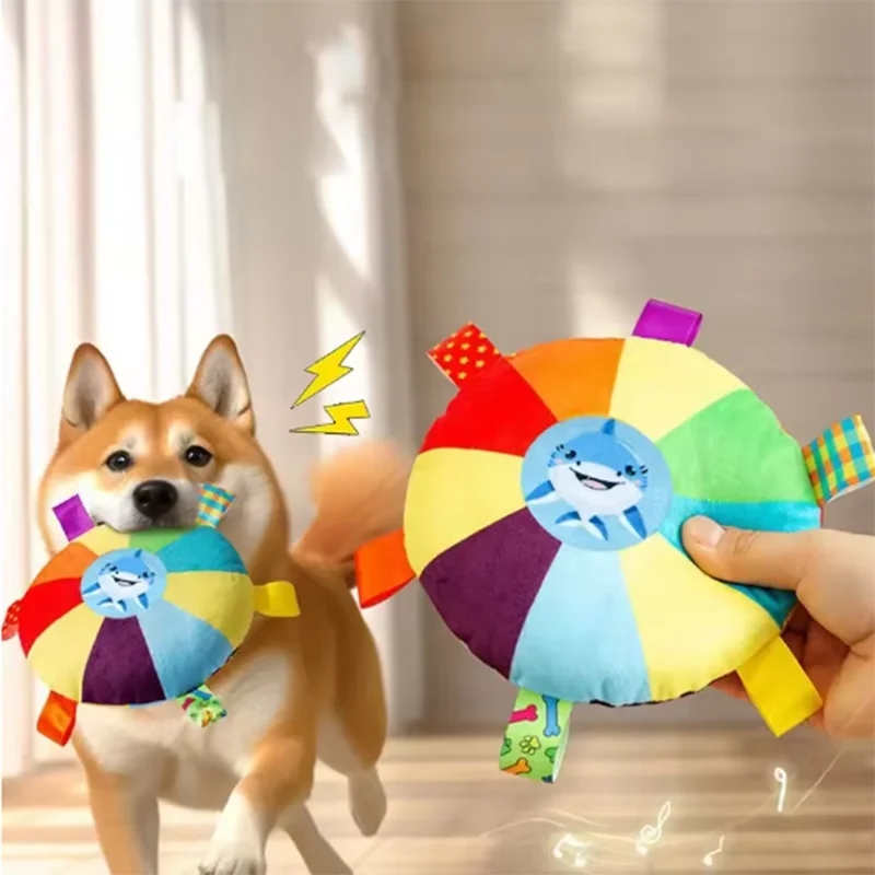 Shiba Inu playing with colorful plush shark dog toy, perfect for interactive pet playtime and training.