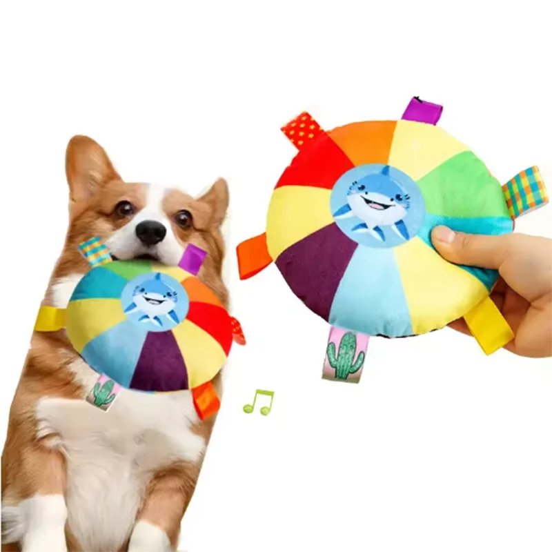 Corgi playing with colorful shark plush dog toy, perfect for interactive pet play and chew sessions