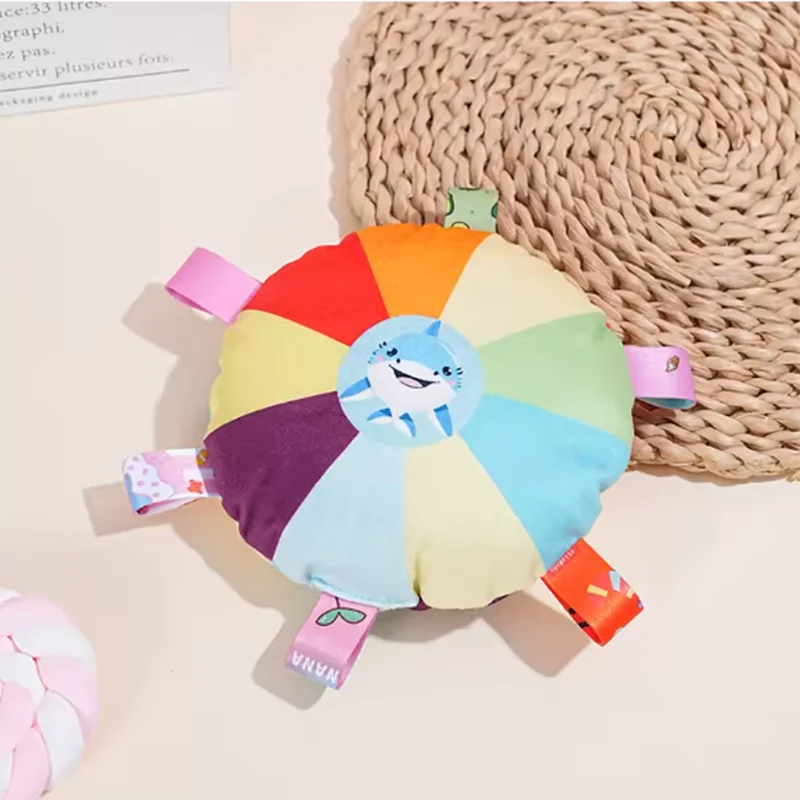 Colorful rainbow pet toy with shark face and fabric tags for chewing and play